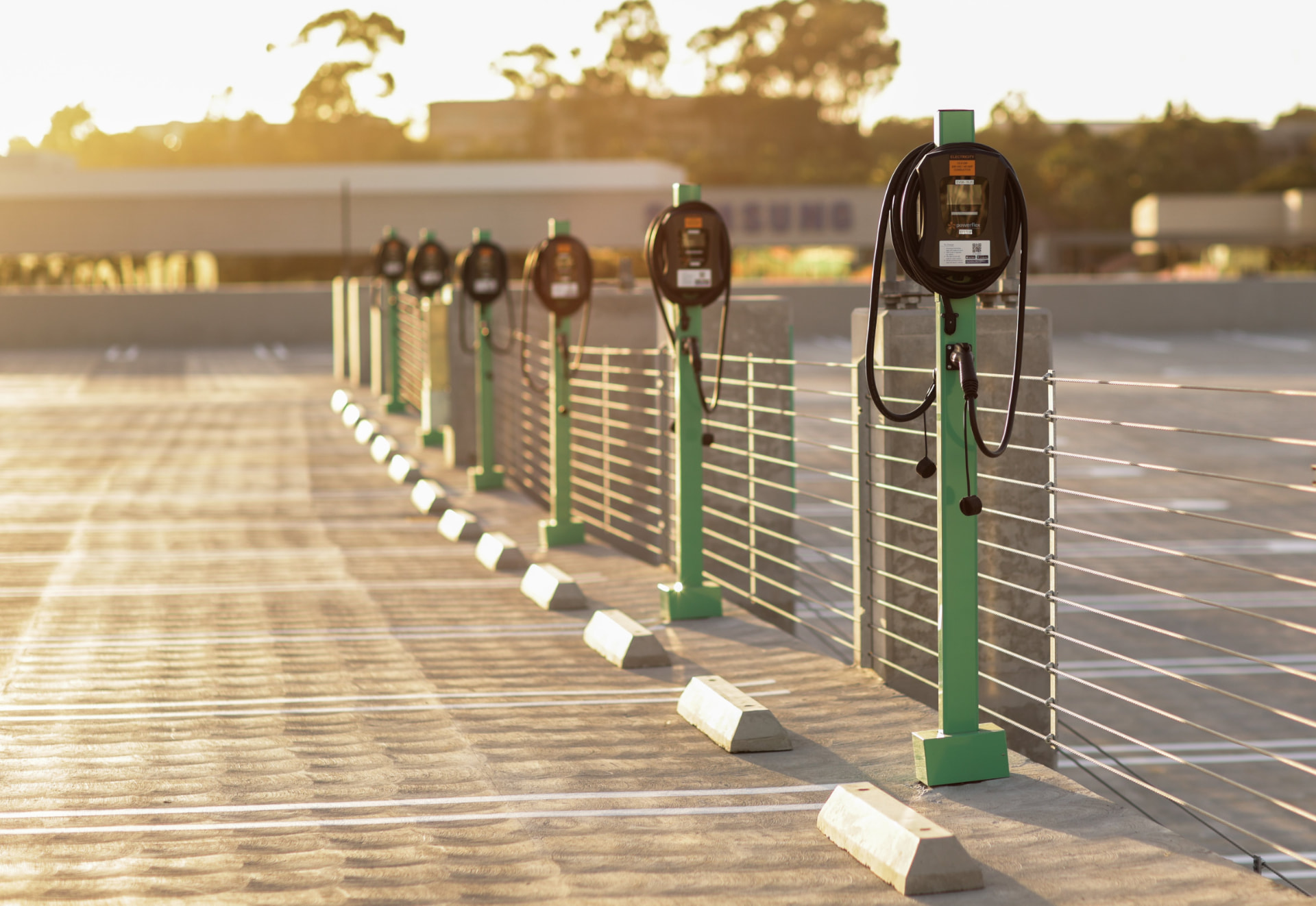A row of electric vehicle charging stations in a parking facility